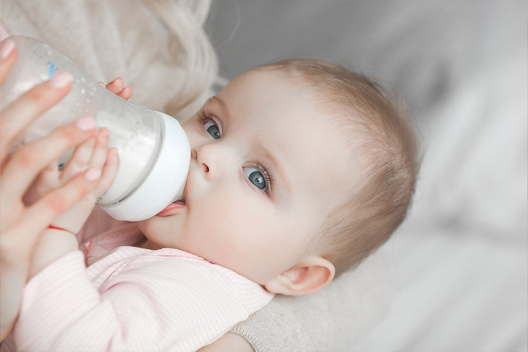 Bébé buvant au biberon.