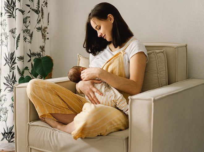 A woman breastfeeding her baby.
