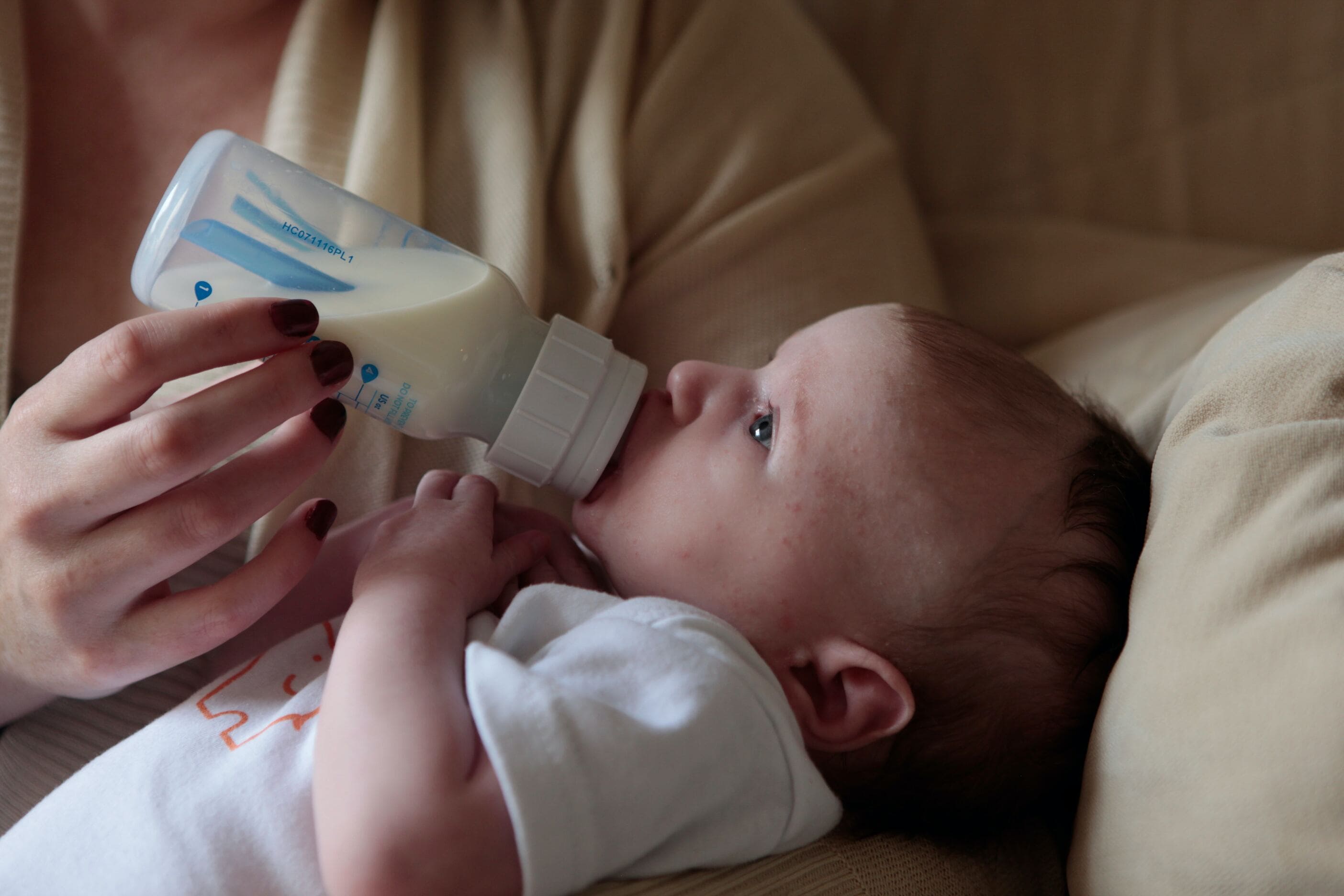 Baby being bottle fed.