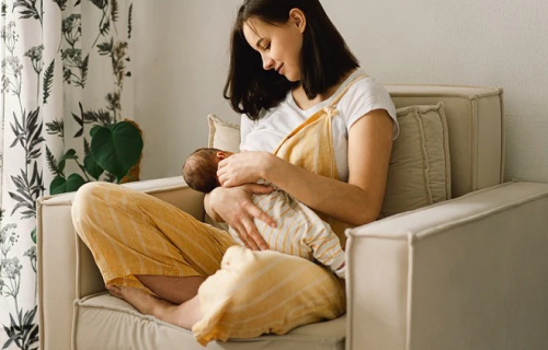 Femme allaitant assise sur une chaise.